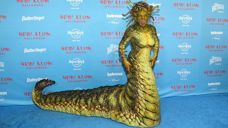 Heidi Klum posing on step-and-repeat in Medusa costume