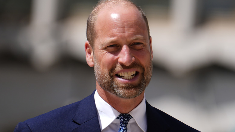 Prince William gurning in a navy suit
