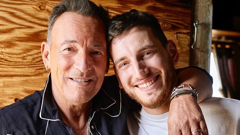 Bruce Springsteen and Sam Springsteen arm-in-arm, both smiling