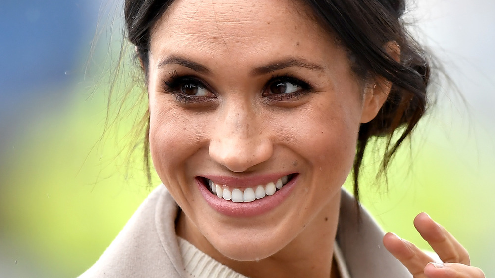 Meghan Markle poses at an event