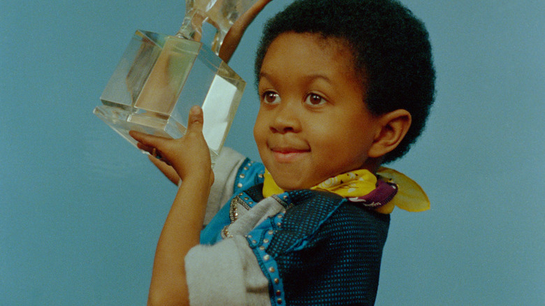 Emmanuel Lewis holding an award