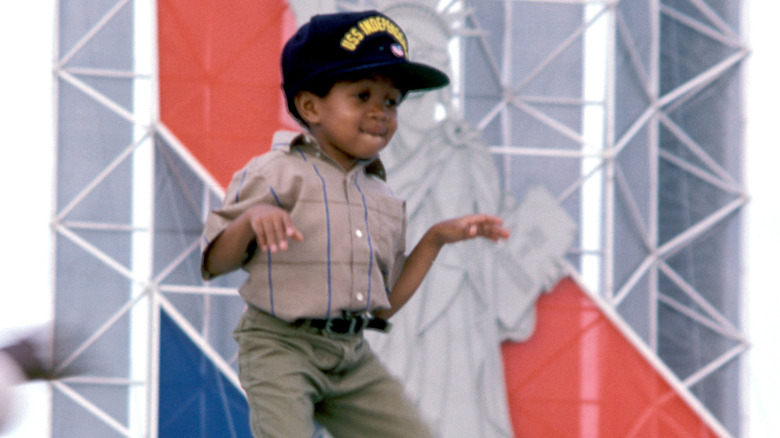 Emmanuel Lewis wearing a black baseball cap