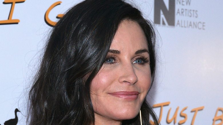 Courteney Cox smiling on red carpet