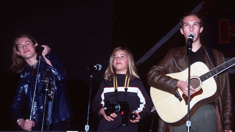 Hanson performing onstage in the 90s 