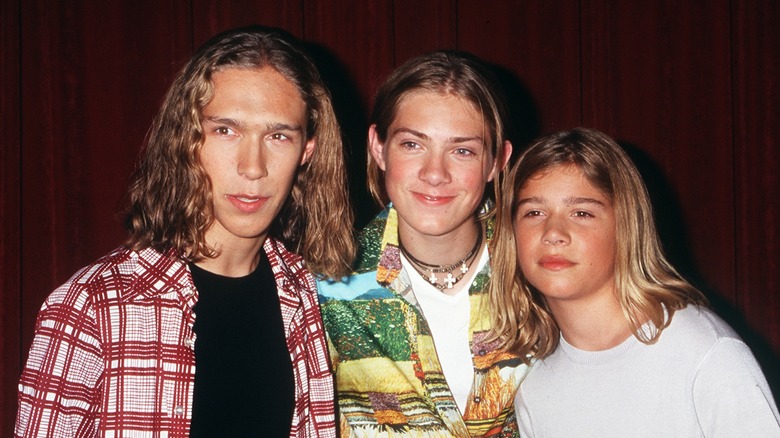 The Hanson brothers posing in the 90s