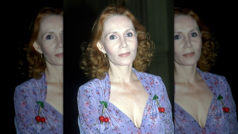 Katherine Helmond wearing a purple dress with cherry pins in a portrait circa 1985