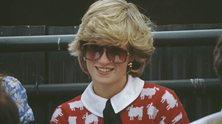 A smiling Princess Diana wearing sunglasses