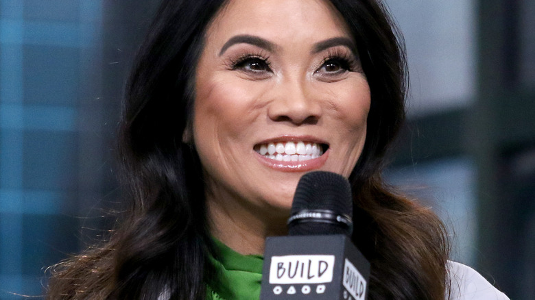 Dr. Sandra Lee smiling with microphone