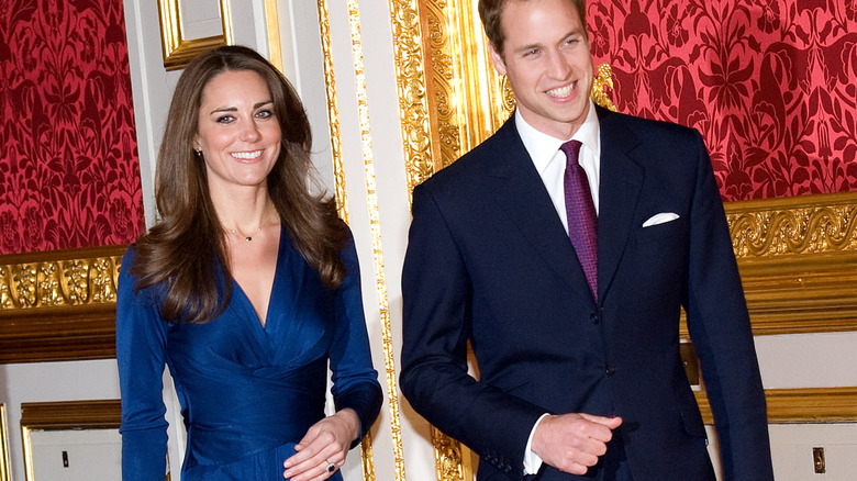 A newly-engaged Kate Middleton and Prince William smile for a photo