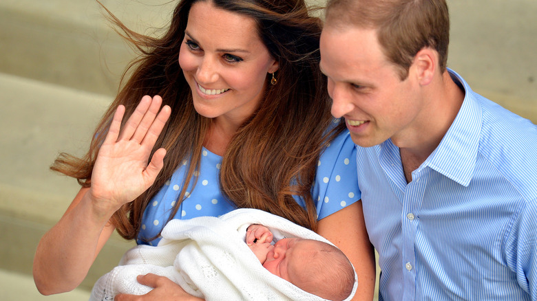 Kate Middleton and Prince William pose for a photo with their newborn son