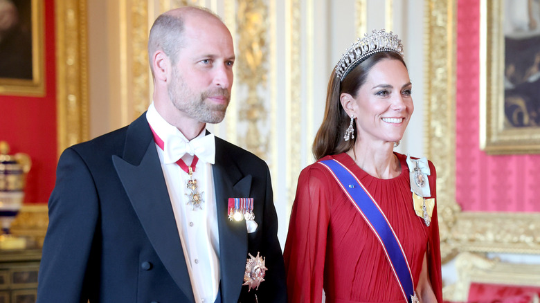 Prince William and Kate Middleton dressed in elaborate royal outfits