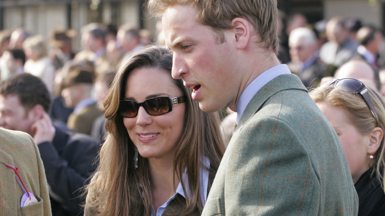 A young Kate Middleton and Prince William talk to fans at a public event