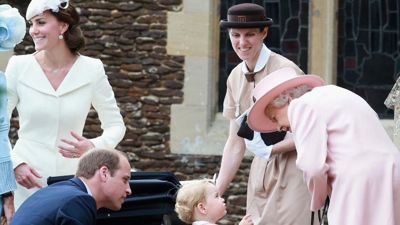 Maria Borrallo smiling at Queen Elizabeth II interacting with a young Prince George