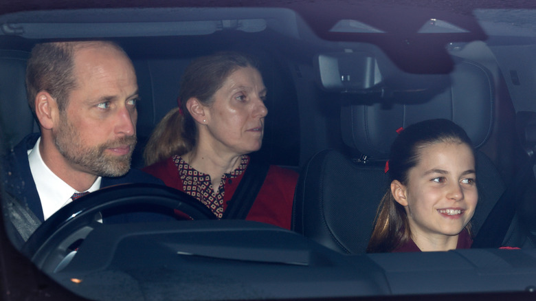Maria Borrallo in the back seat of a car with Prince William driving and Princess Charlotte in the passenger seat