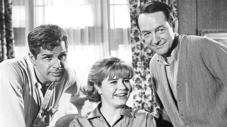 Richard Gautier, Patty Duke, and William Schallert in front of a window