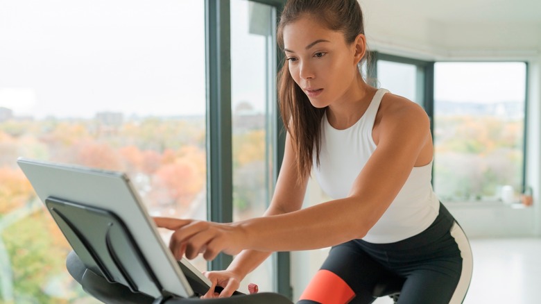 woman working out on an indoor bike