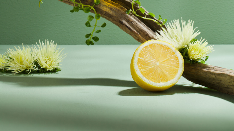 Bottle of perfume and lemon