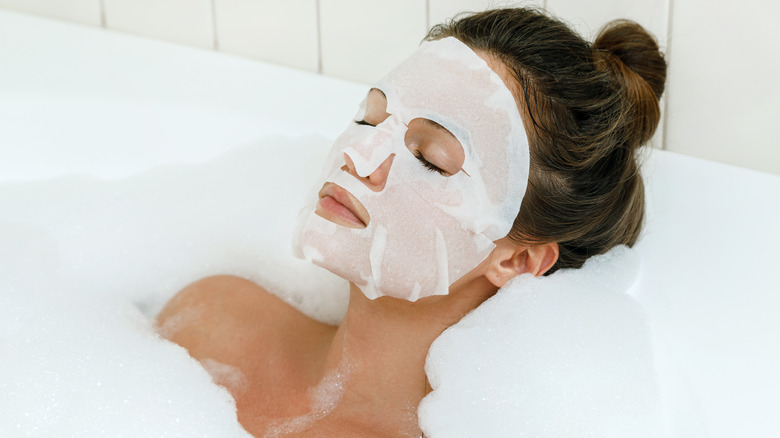 A woman relaxing with a sheet mask on