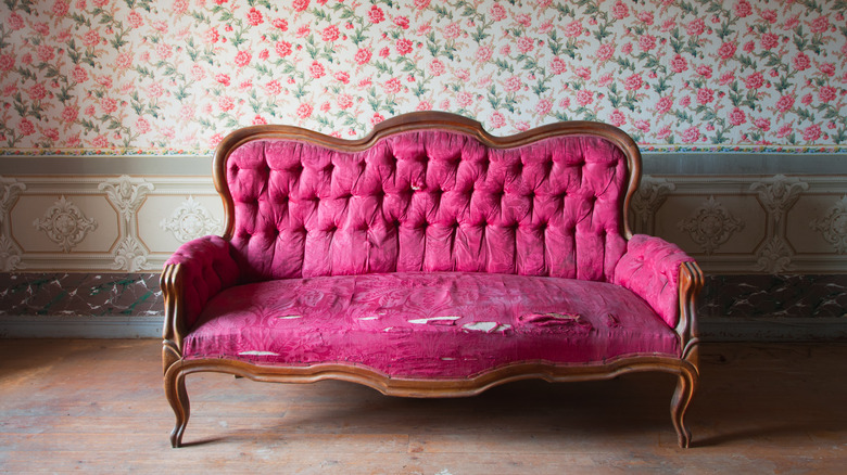 Damaged pink velvet couch