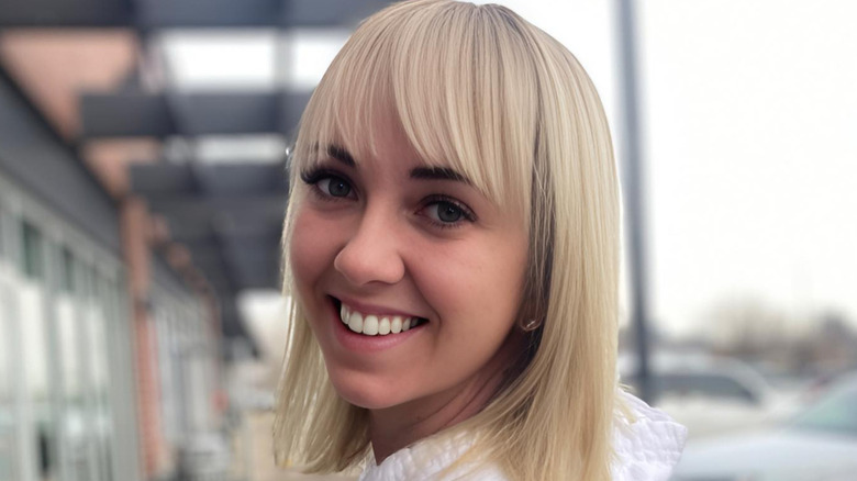 woman with sideswept bangs, short hair and bangs