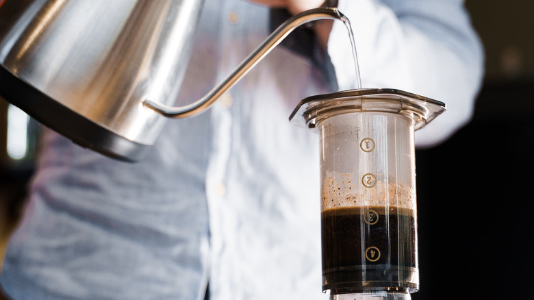 Hot water pouring into an AeroPress coffee maker