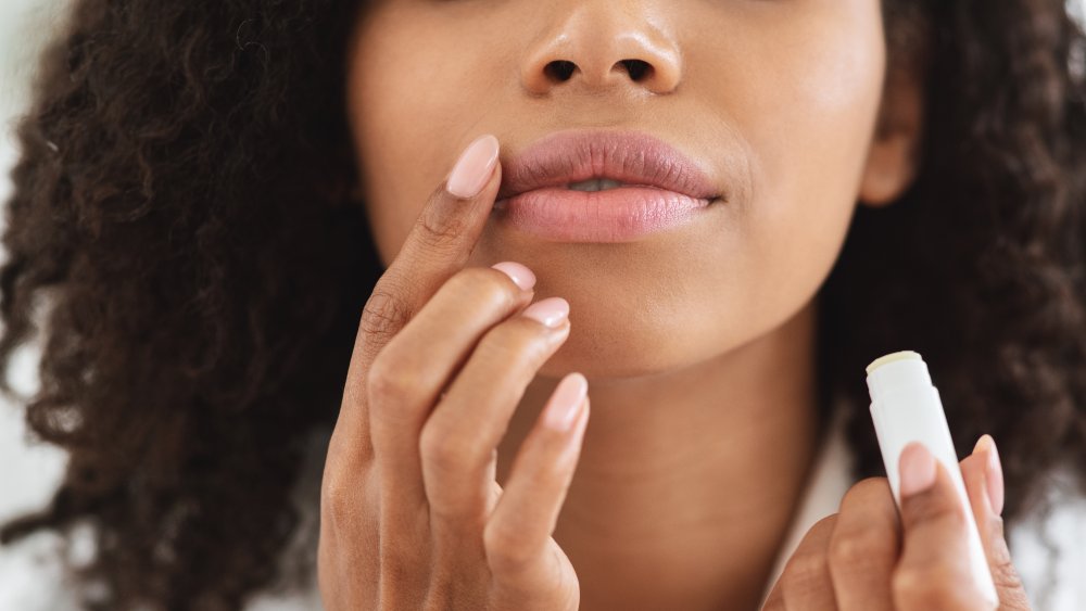 A woman touching her lips 