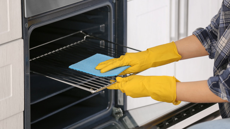 Woman cleaning oven racks