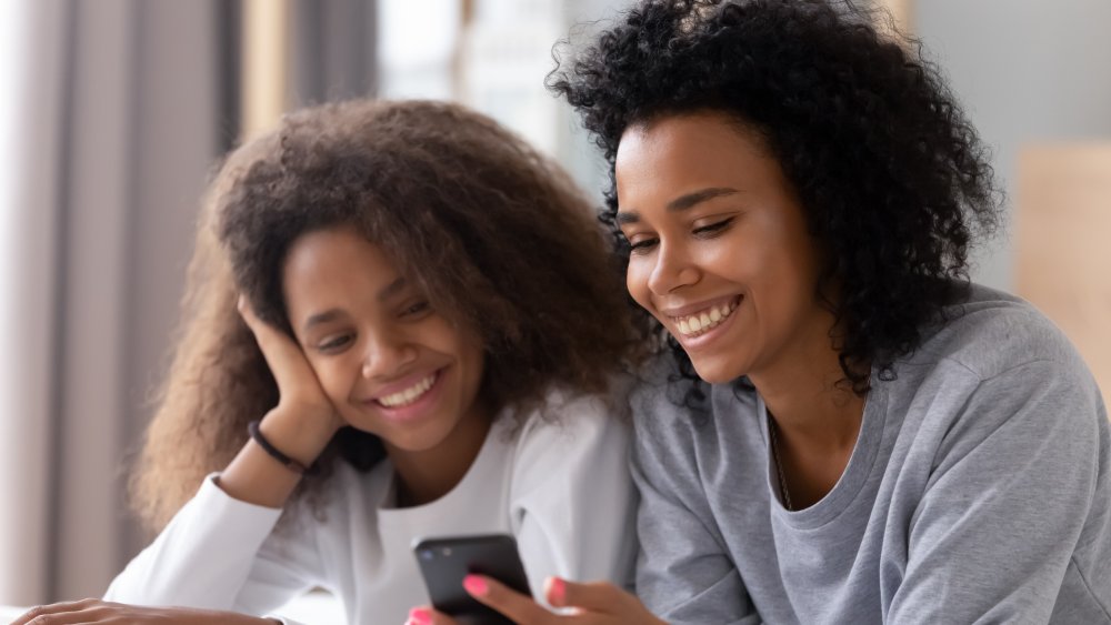 People smiling at phones