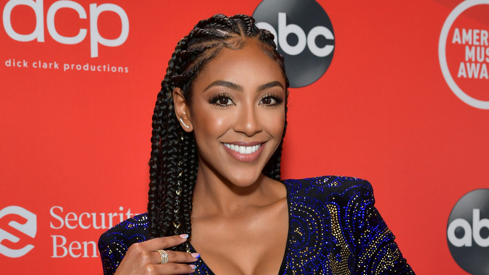 Tayshia Adams smiling on AMA red carpet