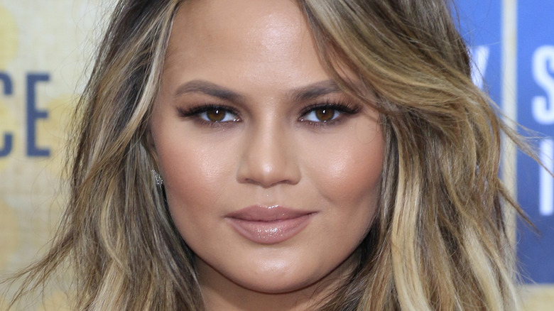 Chrissy Teigen poses with a soft smile