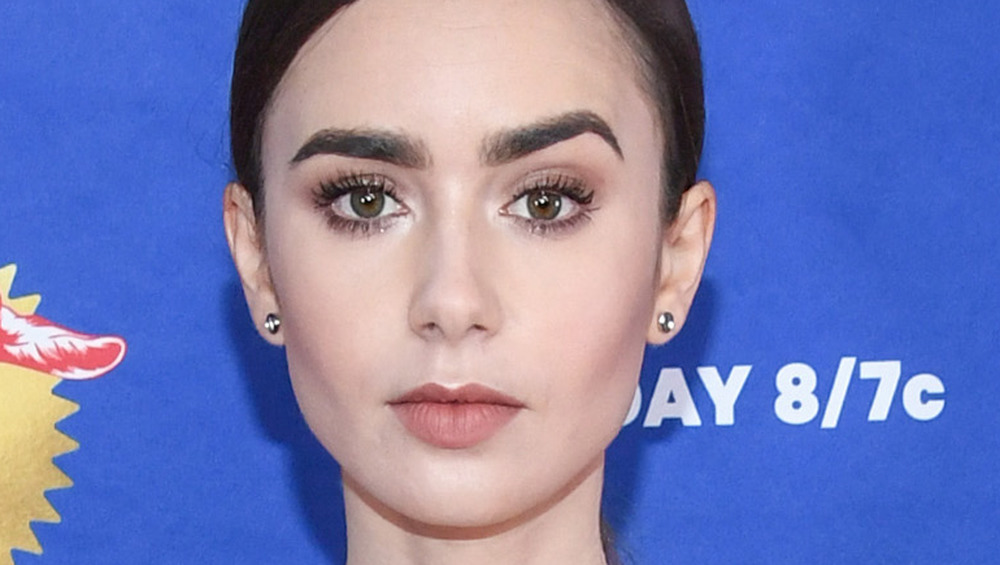 Lily Collins poses on the red carpet for the MTV Movie Award