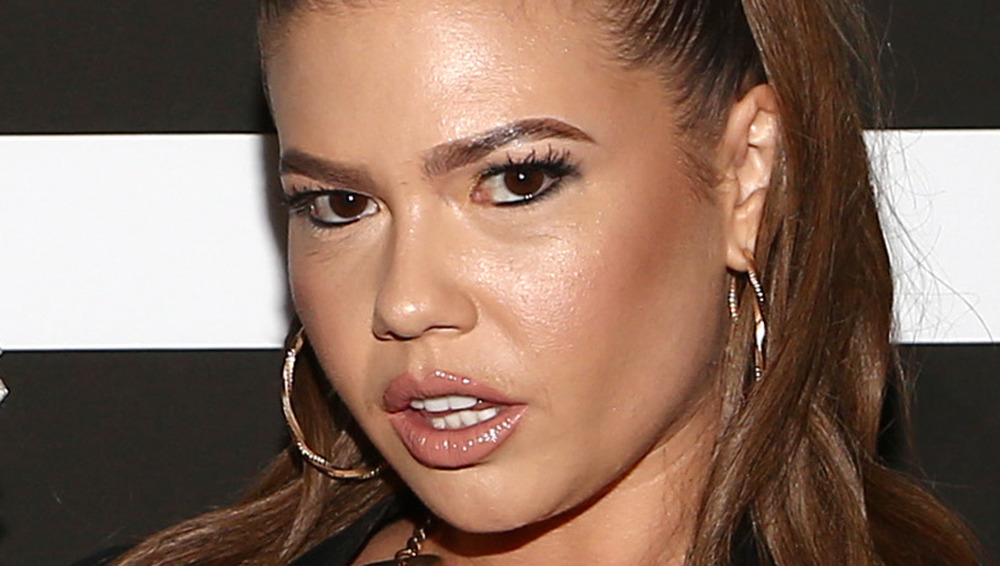 Chanel West Coast with mouth slightly open and hoop earrings