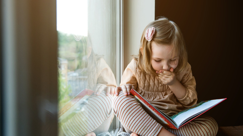 Little girl reading a book