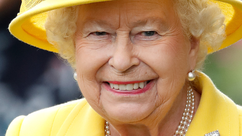 Queen Elizabeth smiling in yellow