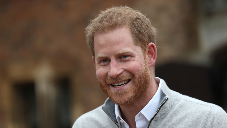 Prince Harry smiles at an event