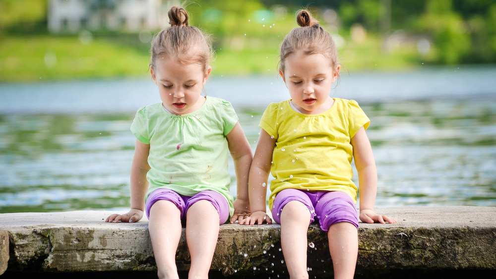 Identical twins sitting together