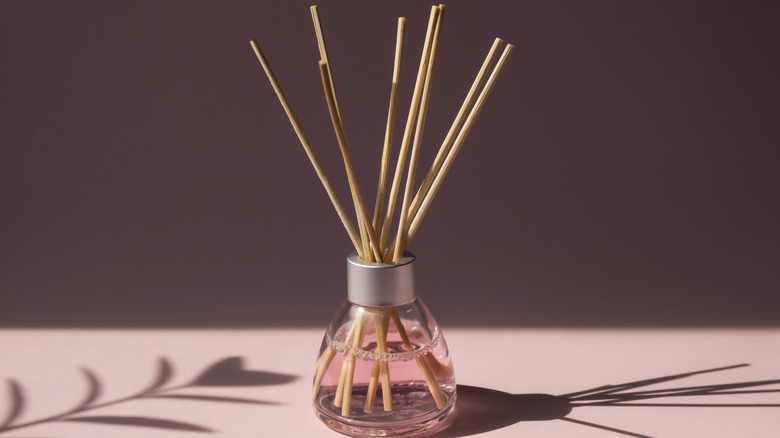 Reed diffuser with pink liquid