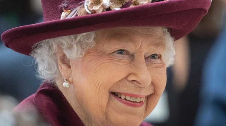 Queen Elizabeth smiling purple suit