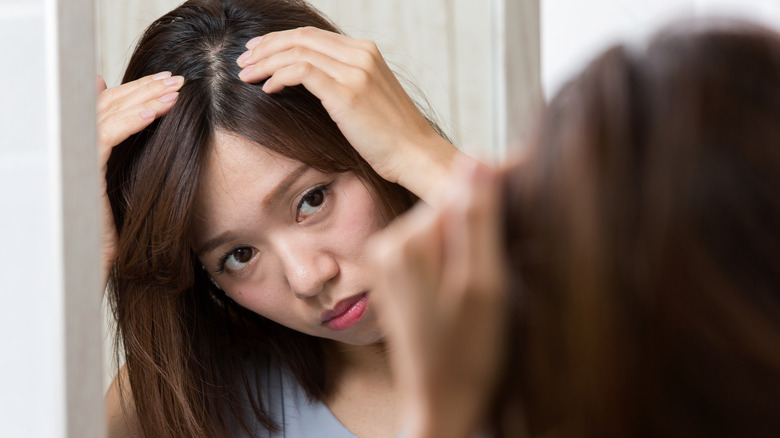 Woman looking at her scalp