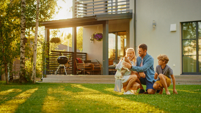 A family playing in their yard