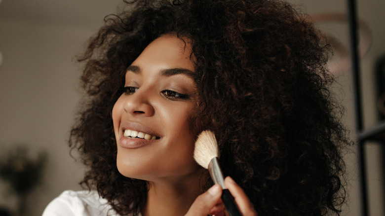 Woman applying makeup