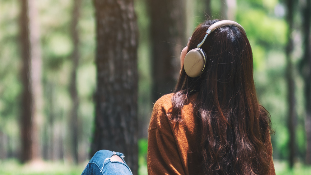 Woman in the park listening to music