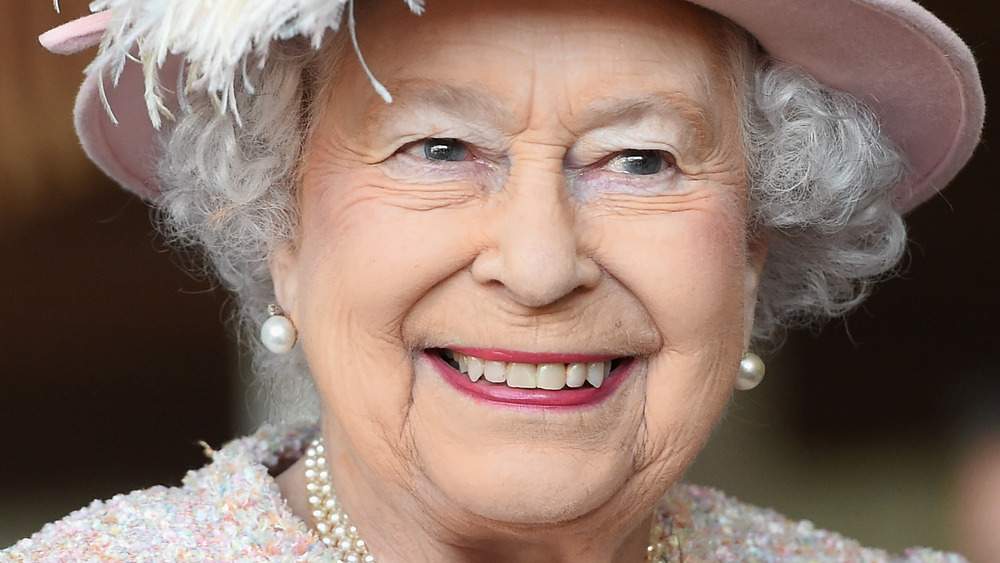 Queen Elizabeth smiles in pink