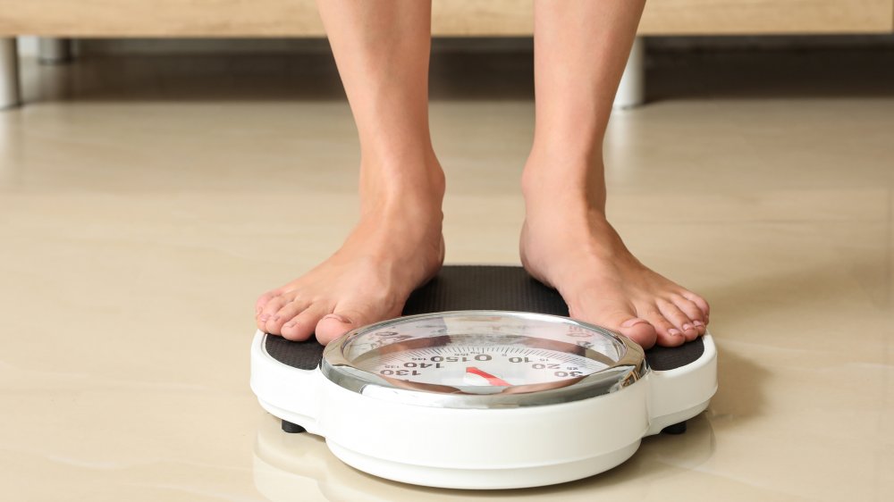 Woman weighing herself