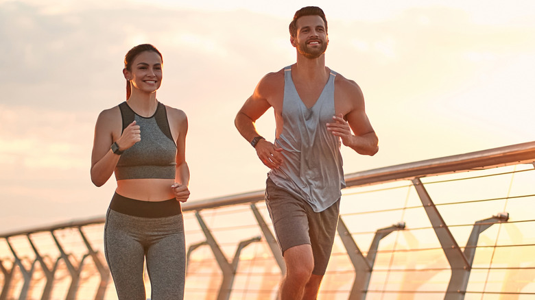 Woman and man jogging together