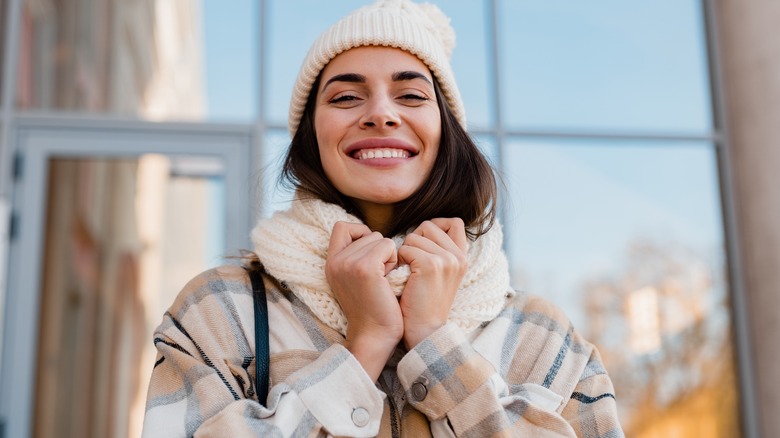 Woman bundled up in a winter jacket, scarf, and beanie hat