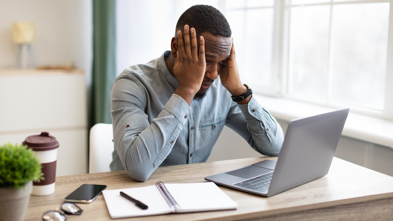 Man stressed at a computer