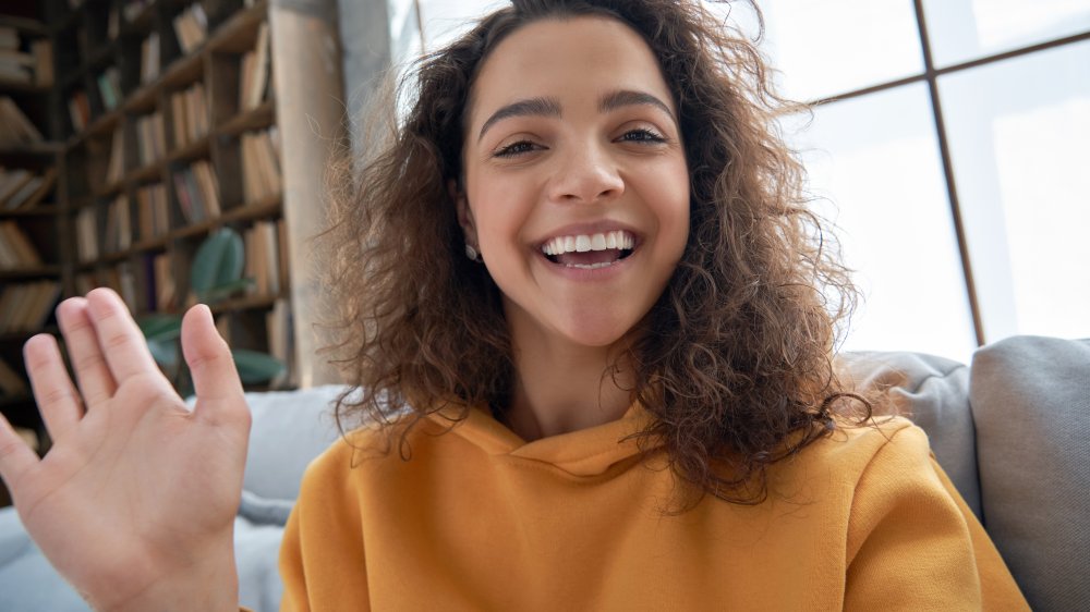 Girl smiling and waving