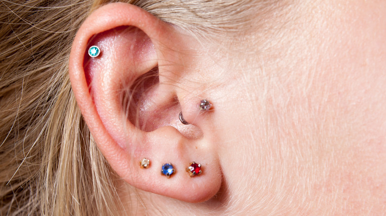 person with multiple ear piercings