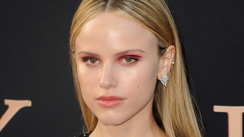 Halston Sage posing at event
